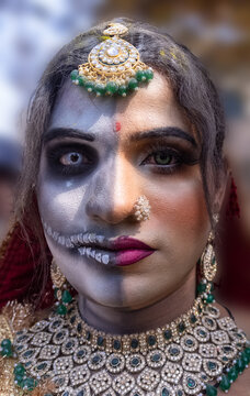 Masan Holi, Portrait of an male artist act as lord shiv and goddess parvathi with dry colours on face and body during celebrating the holi festival as tradition at ghat in varanasi, India.