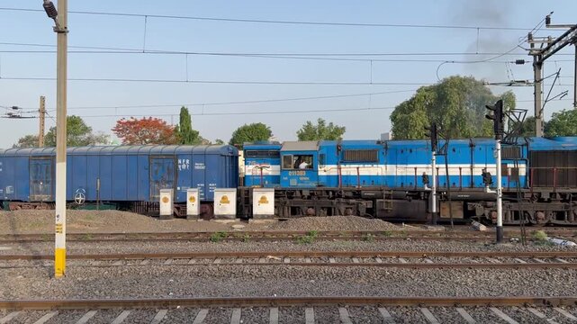 Moving train on railway tracks representing rail transport, public transportation, travel, mobility, and transportation infrastructure