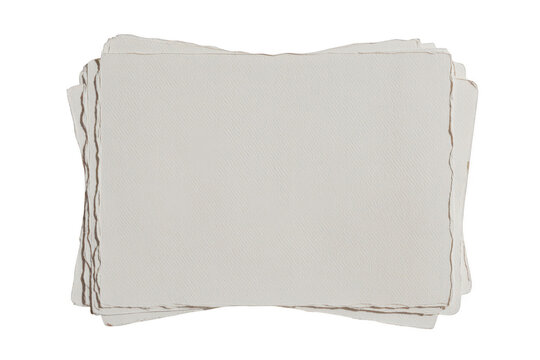 A stack of thick, textured white paper sheets with rough, deckled edges, isolated on a black background, stationery for and calligraphy
