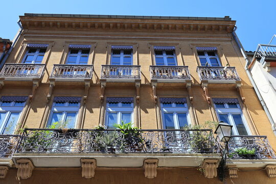 Historic facade with balconies in the French city of Toulouse  