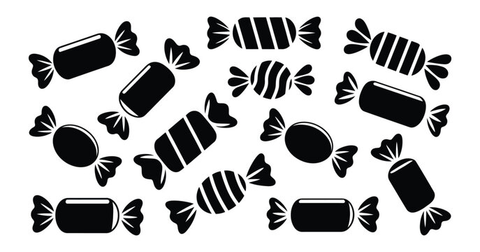 Collection of black and white candy wrappers in various shapes and sizes scattered on a clean isolated background sweet treat concept