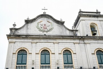 Fototapeta premium Neoclassical grey facade of historic St Lazarus Church built in 1557 and rebuilt in 1885 at street corner