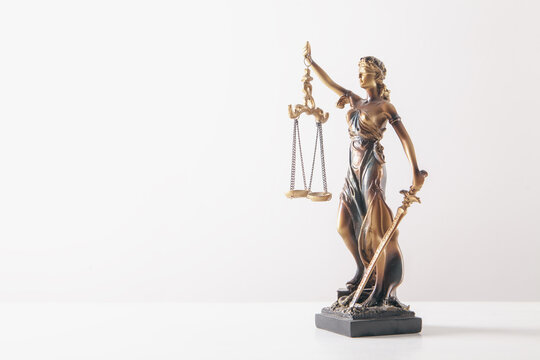Statue of justice with scales on white background. Law and justice concept.