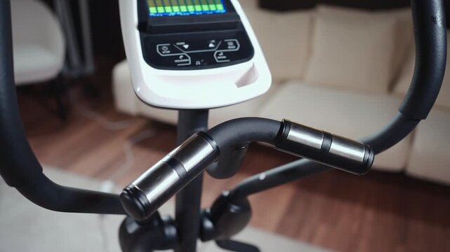 closeup of cross trainer with sensor handlebar or monitor with pulse indicator