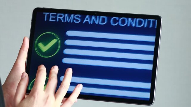A person is looking at a tablet screen that shows a list of terms and conditions. The screen has checkmarks, indicating progress. The light is bright, creating a focus on the device.