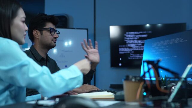 Professional IT specialist and programmer working on software development, Male developer talking with female colleague about computer code, Modern coding team and technology collaboration concept