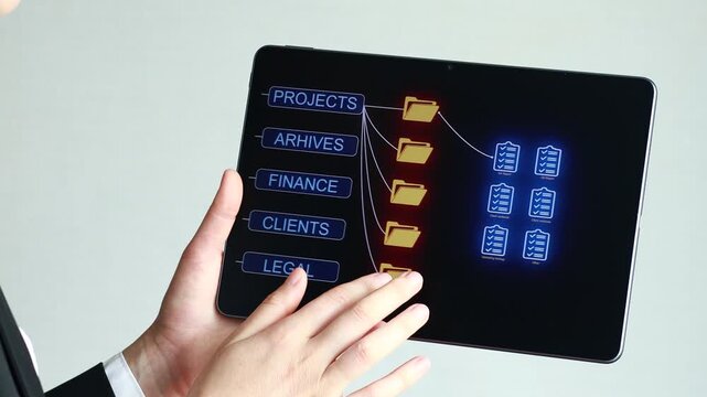 A person uses a tablet displaying project folders and finance data in an office. Different categories like clients and legal are shown. The setting is modern and professional.