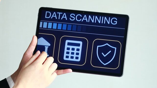 A person holds a tablet displaying a data scanning screen. The screen shows a progress bar and icons for a bank, a calculator, and a security shield. This scene takes place indoors.