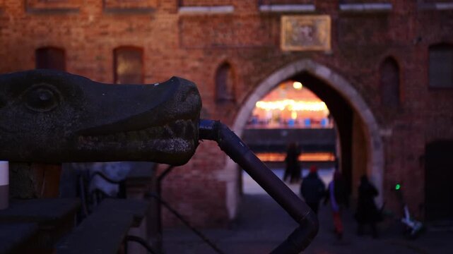 Gargoyle next to St. Mary's Gate at night. Gdansk, Poland.