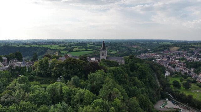 Picturesque aerial view revealing the historic medieval town of thuin. Featuring its iconic belfry and lush green landscape nestled along the sambre river valley in the beautiful belgian countryside