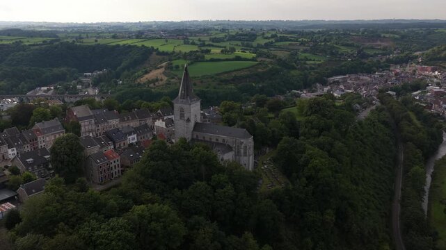 Stunning aerial footage revealing the historic belfry of thuin, a unesco world heritage site, nestled on a hill overlooking the sambre river and the picturesque belgian countryside