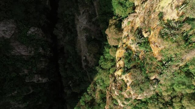 Close up aerial top down view of rocky canyon walls, vegetation, and ravine in La Garita Canyon