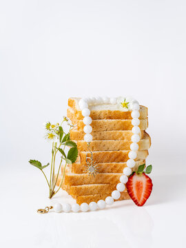 White  jade beads necklace on a stack of toast bread