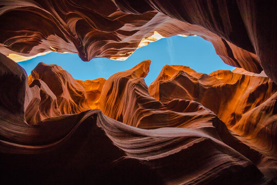 Low angle view  of layered red rock inside slot canyon