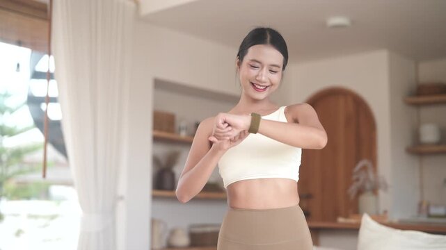 Fitness woman look at smartwatch checking heart rate, calories burned, tech in home gym, fitness, health tracking, self care, technology and healthy living, digital wellness