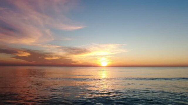 Sunset over calm ocean water horizon.