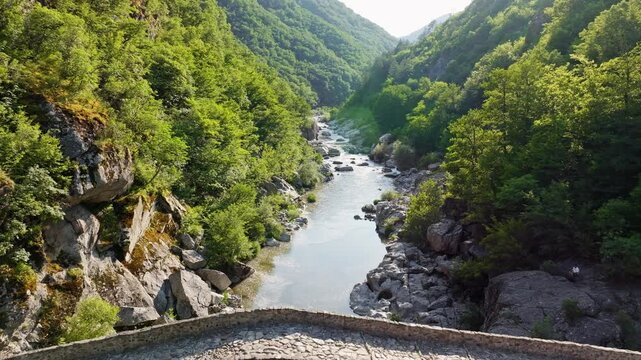 Devil Bridge ancient stone arch Arda river gorge Bulgaria Rhodope mountains aerial view medieval landmark travel heritage green canyon slow motion summer scenic tourism Balkans