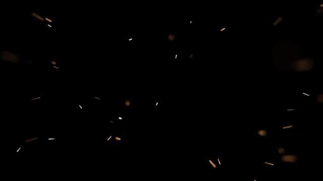 Floating glowing fire embers rising against a dark black background