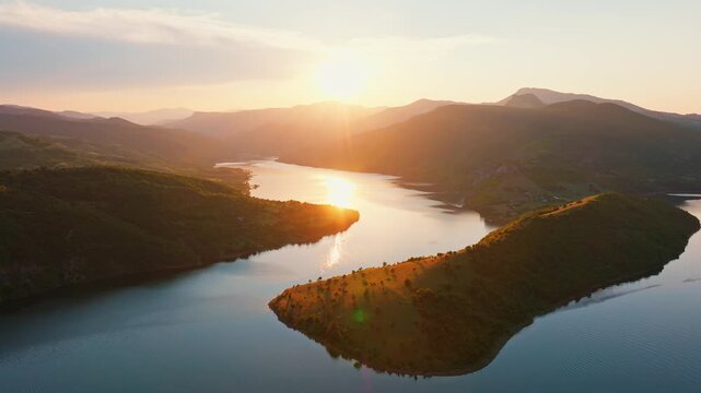 Kardzhali reservoir sunset golden hour aerial drone Bulgaria Rhodope mountains winding lake reflection warm light orange sky nature landscape slow motion travel scenic Balkans overview