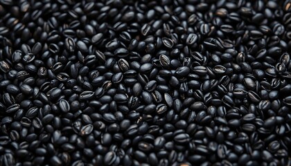 Obraz premium Closeup of dark roasted coffee beans texture background