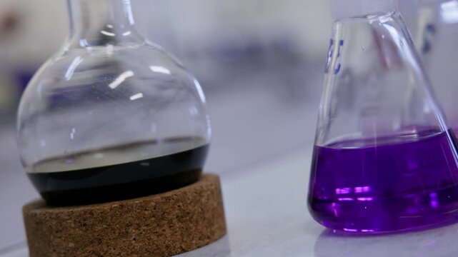 Oil fuel chemical solutions in glass flasks on industry laboratory.