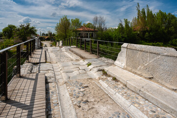 Fototapeta premium Detailed view of the historic Roman Bridge in Aizanoi Ancient City, showcasing ancient stone pavement and Roman engineering