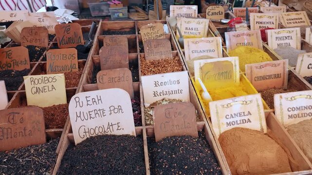 Spanish market spice stall wooden boxes turmeric cinnamon cumin colorful assortment street bazaar Spain authentic food culture travel photography slow motion vibrant organic herbs texture