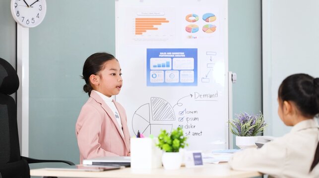 Young Asian Girl in Pink Blazer Giving Business Presentation in Office