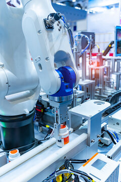 plastic bottles on the production line of the conveyor at robotic machine in the factory. madical and industrial concept