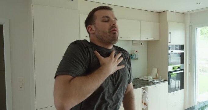 a man choking while eating and coughing food back out, representing airway obstruction, choking emergency, first aid awareness, eating accidents, health risks, and dangerous situations at home