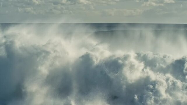 Powerful turquoise ocean wave cresting and breaking with white foam spray
