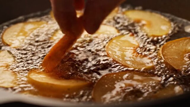 Close-up of apple slices frying in hot oil, creating bubbles and capturing a golden, crispy texture