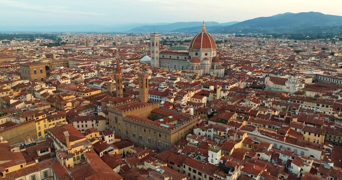 Florence aerial Palazzo Vecchio foreground Duomo sunset Tuscany Italy terracotta rooftops Renaissance cityscape drone warm light travel landmark slow motion Firenze historic tourism overview