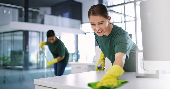 Women, cleaning or office with smile for hygiene, bacteria or germ removal in workplace. Happy, female people or cleaners wiping surface with detergent for disinfection or sanitary workspace together