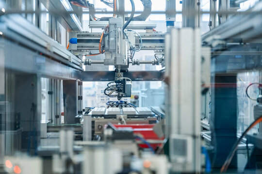 Industrial robot operating automated machinery in modern factory