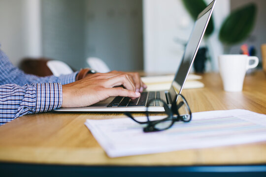 Young man in office using laptop
