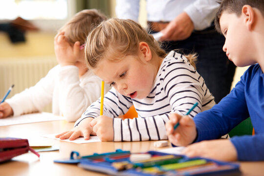 Pupils working on work sheets in classroom