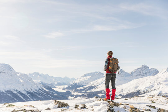 Switzerland, Engadin, hiker in mountainscape looking at view