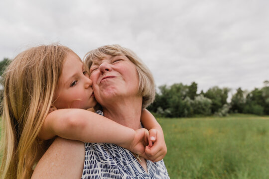 Granddaughter kissing her grandmother