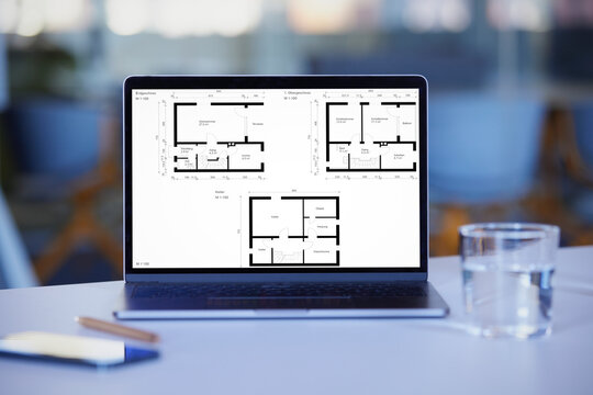 Blueprint on laptop screen at desk in at office
