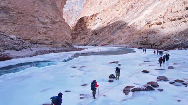 Trekker Walking on Frozen River Mountain Valley