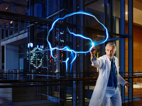 Male neurologist examining brain at laboratory in hospital