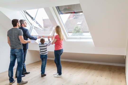 Family and estate agent opening rooflight