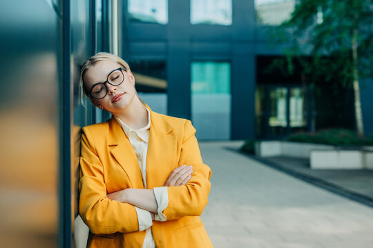 Female entrepreneur resting outside modern office building