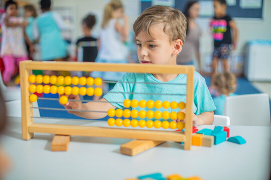 Boy in kindergarten using abacus