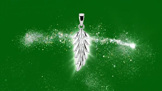 Sparkling Silver Leaf Pendant Floating Against Green Background With Glittering Effects For Jewelry Advertising
