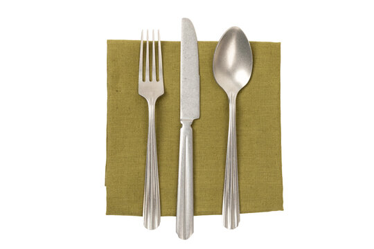 Top view of green napkin, fork, knife and spoon isolated no background cutout