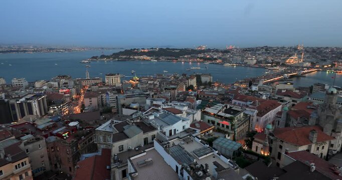 4K left panning motion view of the city skyline of Istanbul, the Galata Bridge and Bosporus inlet on dusk, Istanbul, Turkey, Eastern Europe