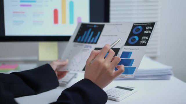 Businesswoman analyzing financial data on a paper report. Professional working with statistics and charts for corporate planning and strategy