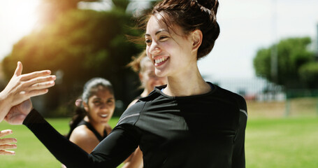 High five, smile and woman with practice on soccer field, training support and celebration for goal. Football competition, winner and player with match point for victory, outdoor and congratulations © peopleimages.com
